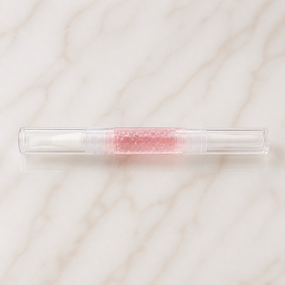Wessiny Cuticle Oil Remover Pen flat lay on ivory marble