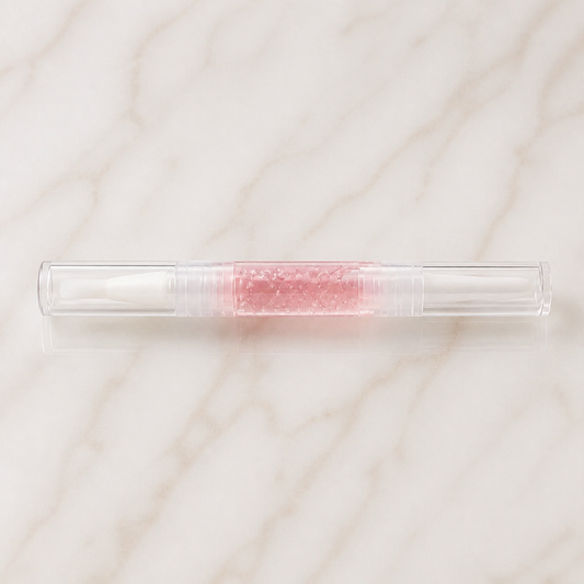 Wessiny Cuticle Oil Remover Pen flat lay on ivory marble